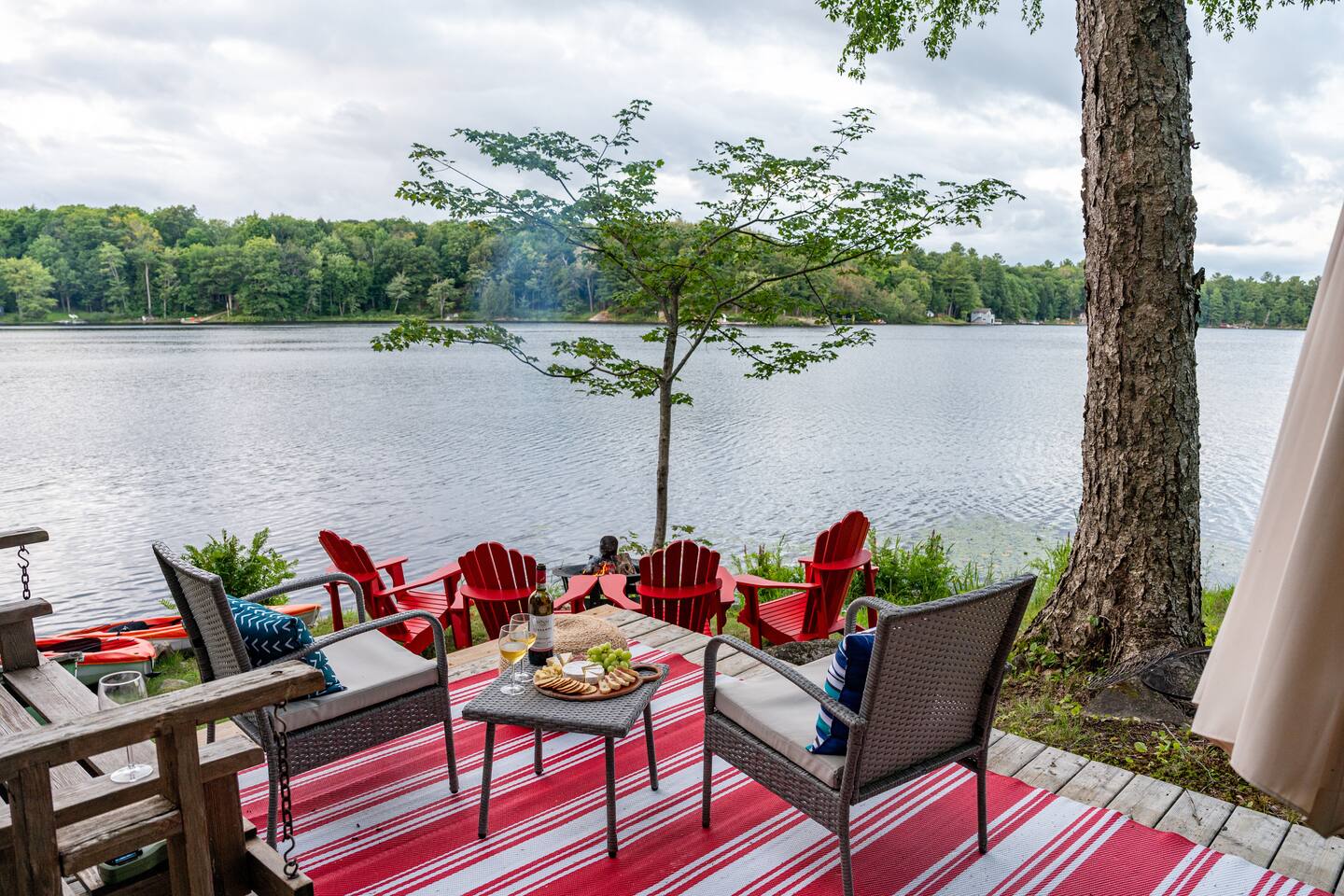Lakeside firepit with Muskoka chairs at golden hour