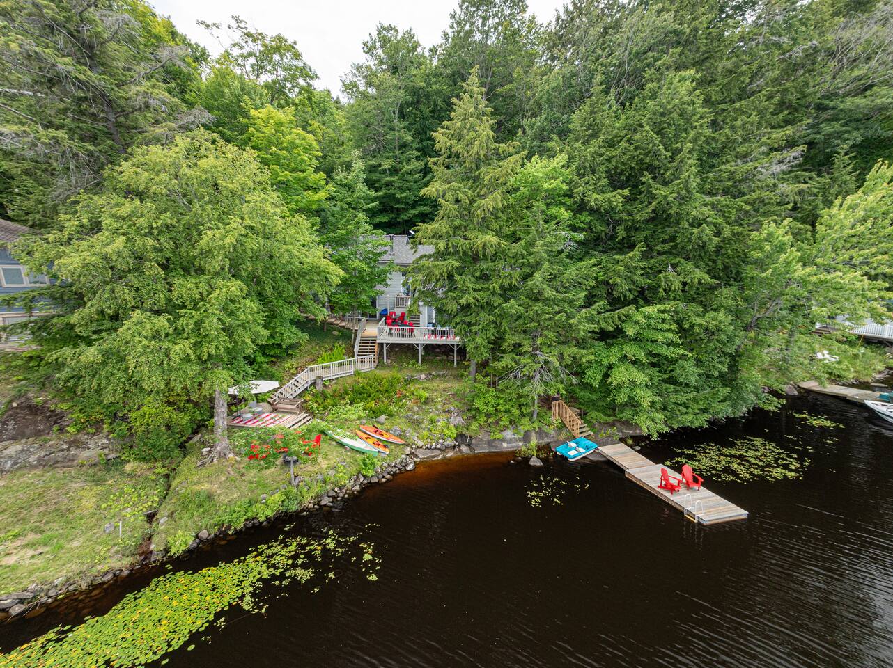 Upper deck with red outdoor dining set and lake view