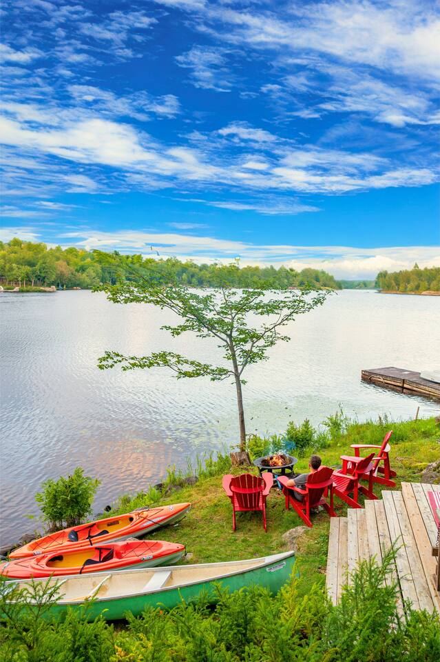 Lower level living area with grey sectional sofa and entertainment center