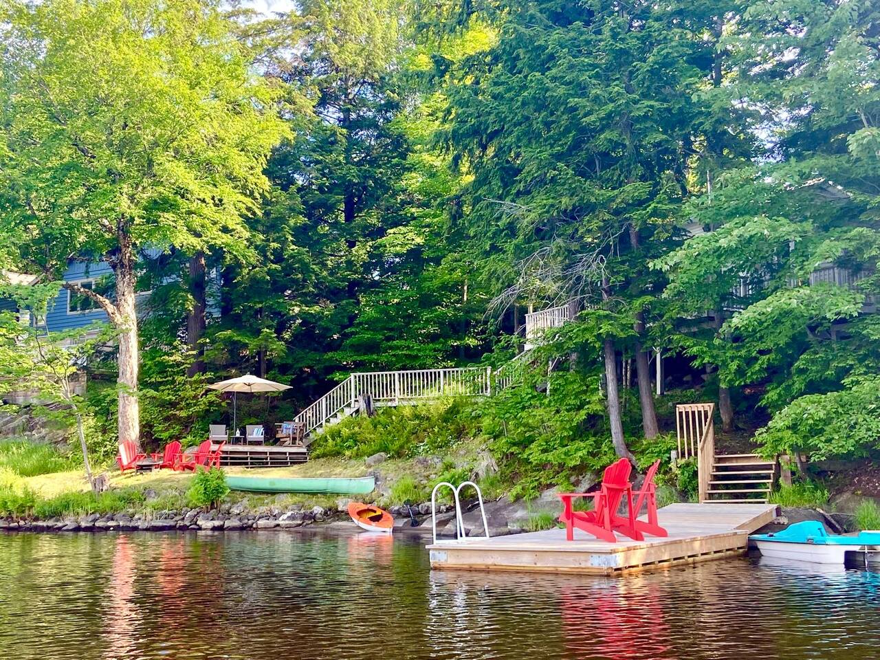 Lakeside firepit with Muskoka chairs at sunset